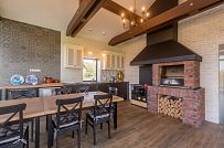 Интерьер летней кухни с каменной печью и панорамным остеклением в д. Пеники от СК Медный Всадник - мини - 6