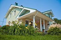 Построенный каркасный дом в п Озерное чуть более 170 кв.м с комбинированной отделкой бежевым кирпичом и зеленой отделочной доской, с террасой, навесом на два автомобиля и четырьмя спальнями - мини - 1