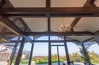 Интерьер летней кухни с каменной печью и панорамным остеклением в д. Пеники от СК Медный Всадник - мини - 7