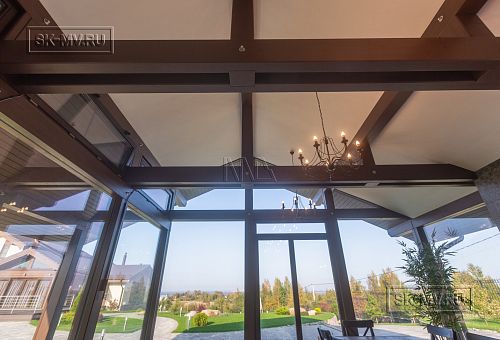 Интерьер летней кухни с каменной печью и панорамным остеклением в д. Пеники от СК Медный Всадник - 7